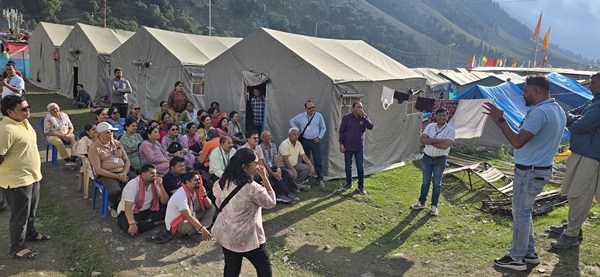 A group posing with the picturesque landscape of Sonmarg